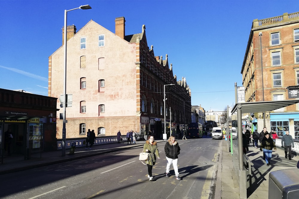 two women walking on road