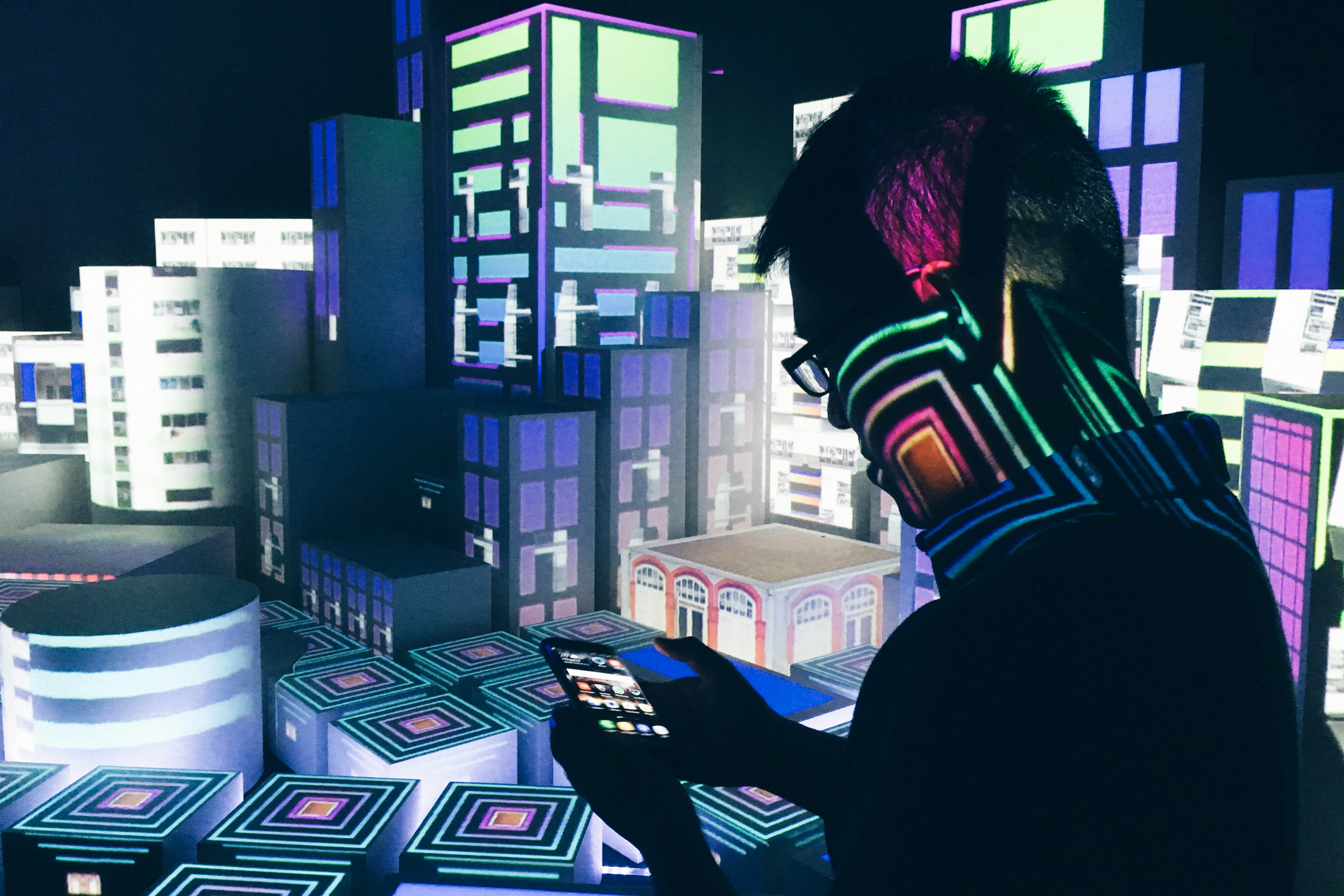 teenager using smartphone to type text prompts creating a colorful 3D virtual world