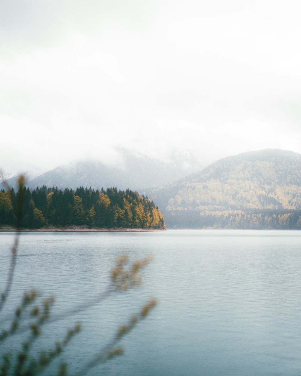 body of water beside hill