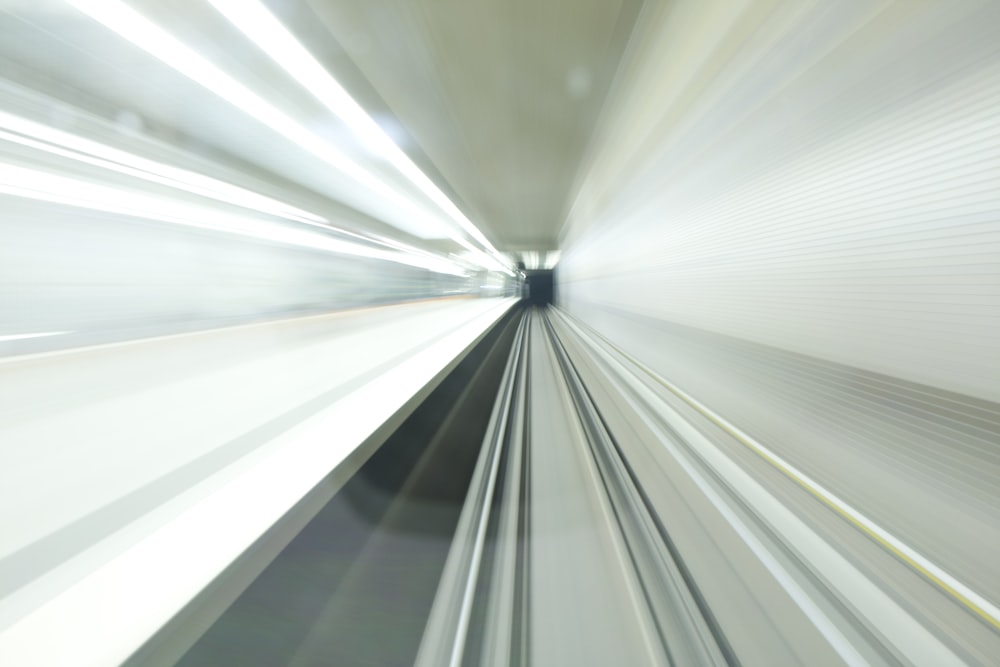 a blurry photo of a train going through a tunnel