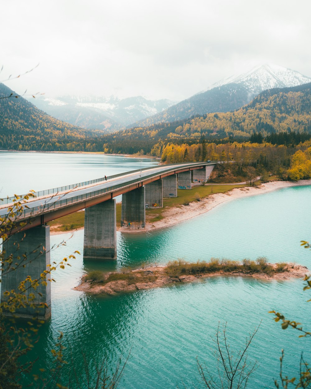 gray concrete bridge over the lake