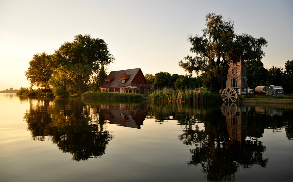 house near body of water during golden hour