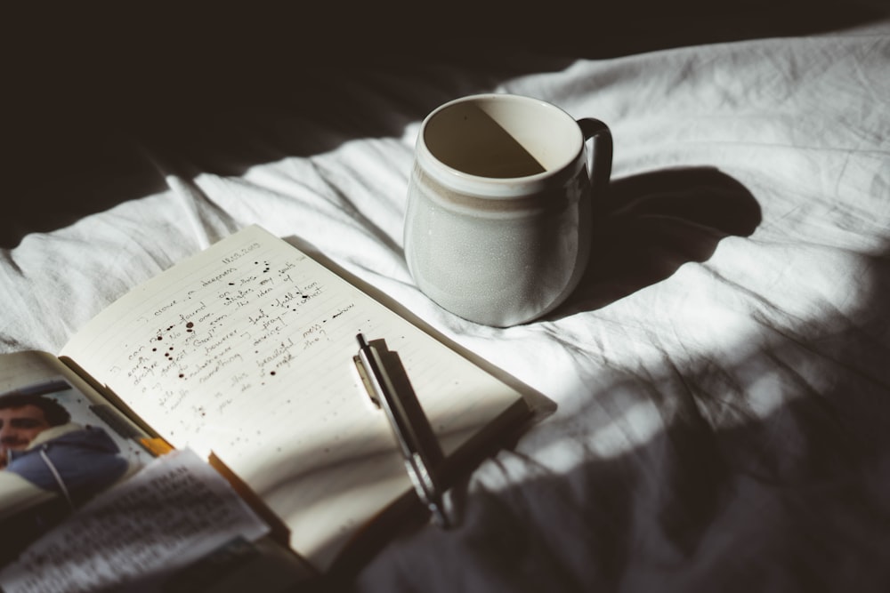 mug and pen beside each other