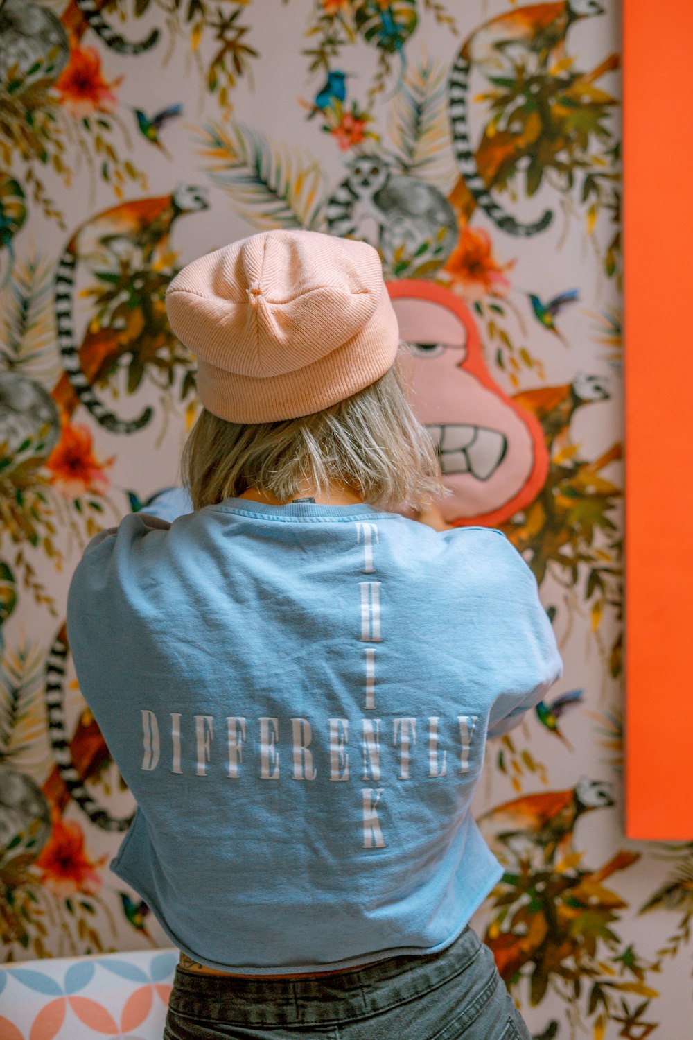 woman in blue shirt and pink hat