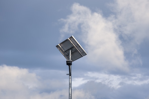 a street light in front of a cloudy skyby C. G.