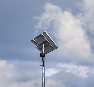 a street light in front of a cloudy sky