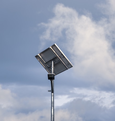 a street light in front of a cloudy sky