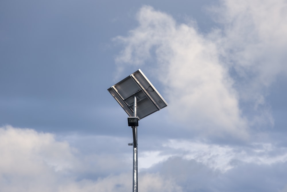 a street light in front of a cloudy sky