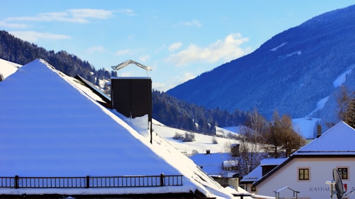 A panoramic view of a freshly completed roof in a Nordic setting with snow in the background.