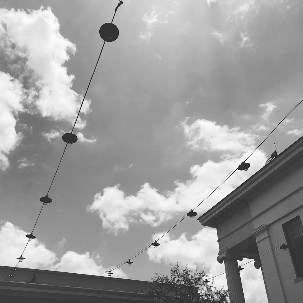 a black and white photo of a building and some wires