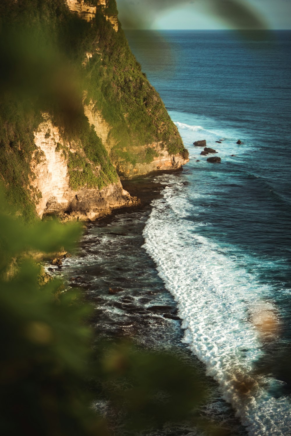 rock formation near body of water during daytime