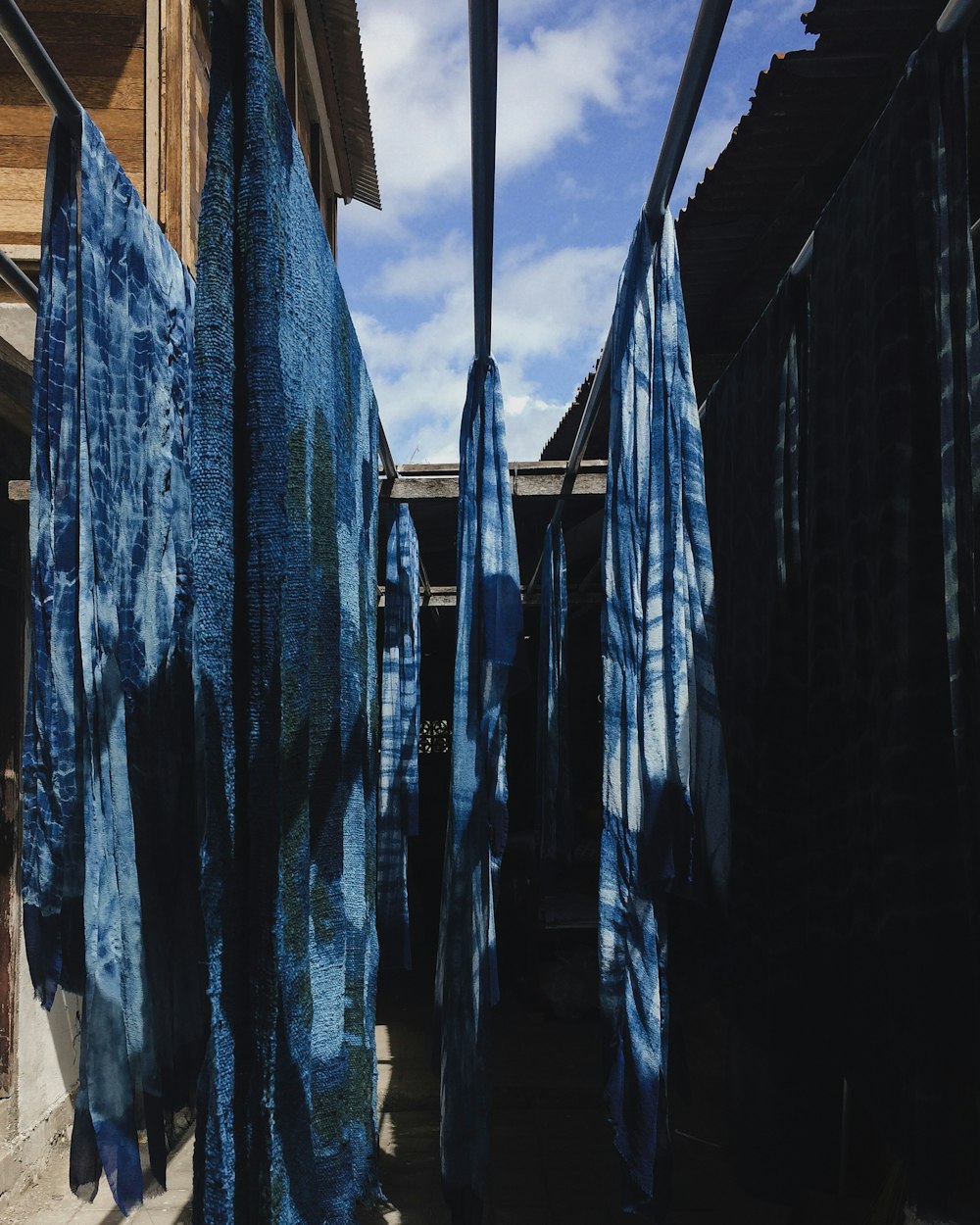 a row of blue towels hanging from a clothes line