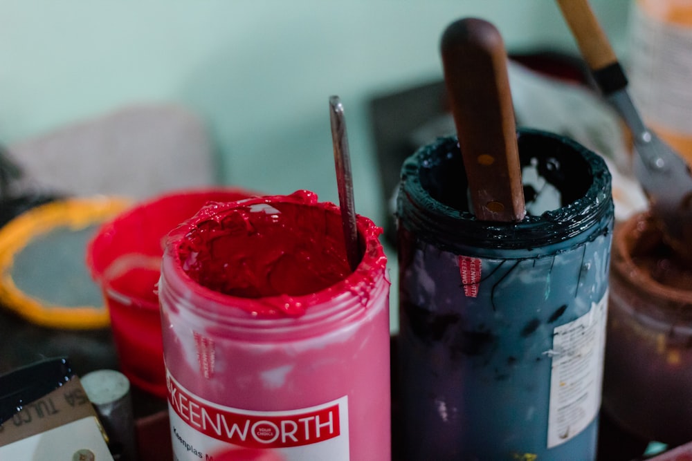 two green and pink paint jars