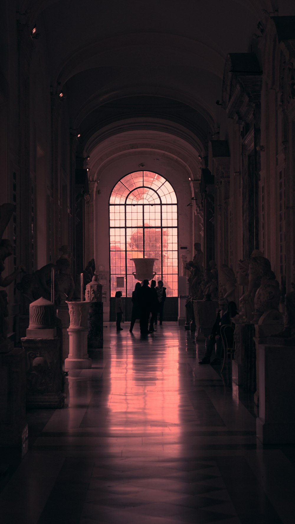 people standing near sculptures