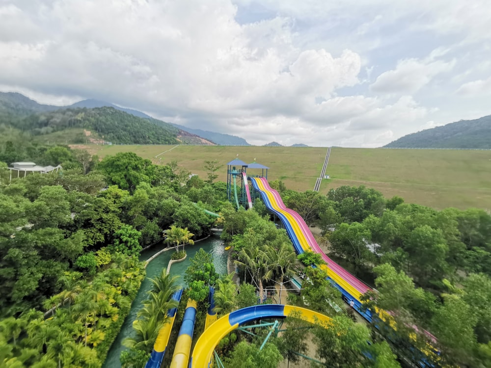 yellow, blue, and pink pool slide near teres