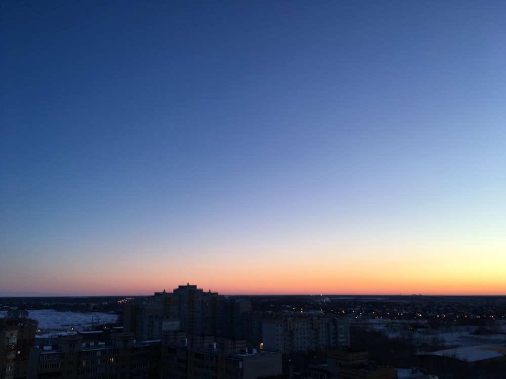 high rise building under blue sky at night