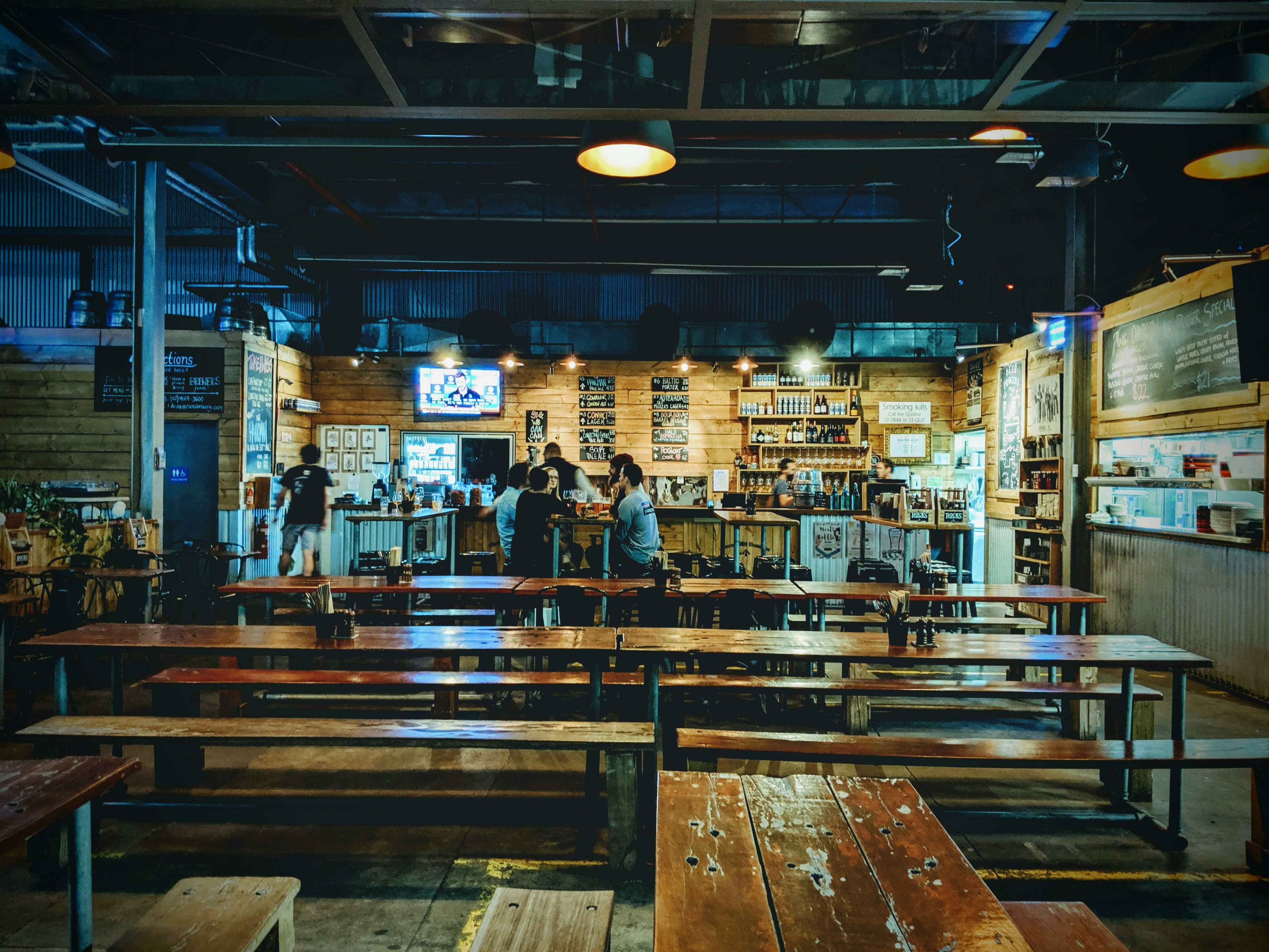 wooden tables and benches inside bar