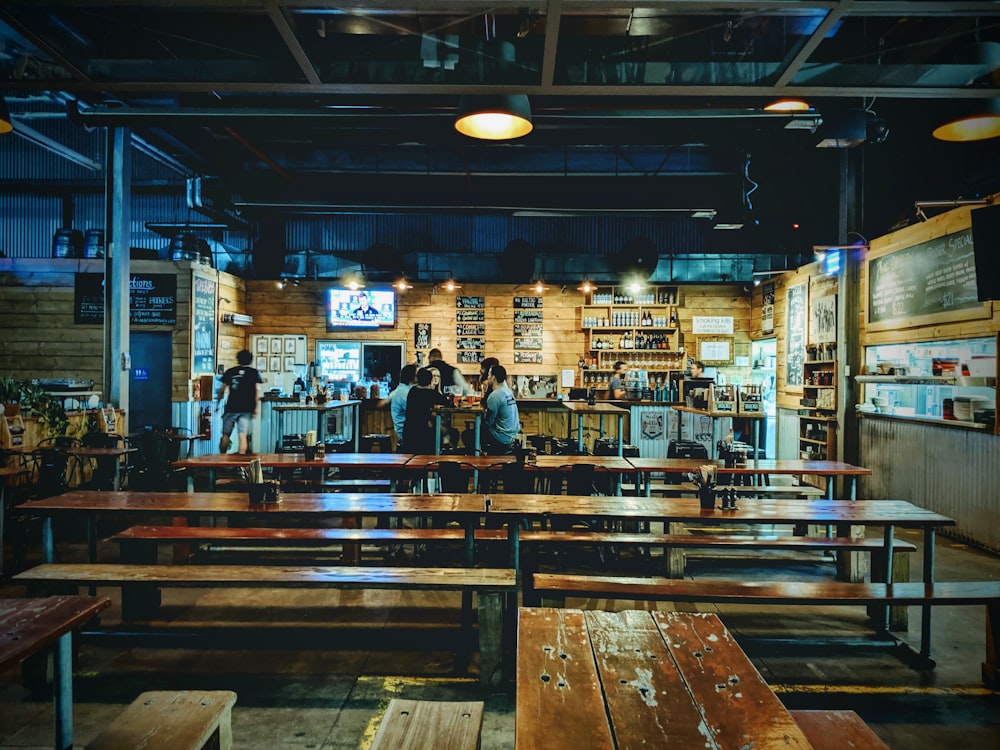 wooden tables and benches inside bar