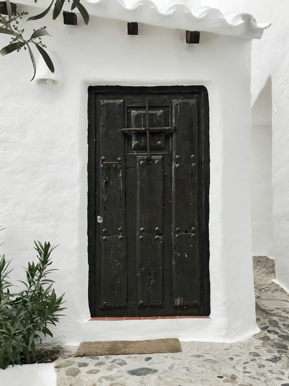 white building with closed black wooden door