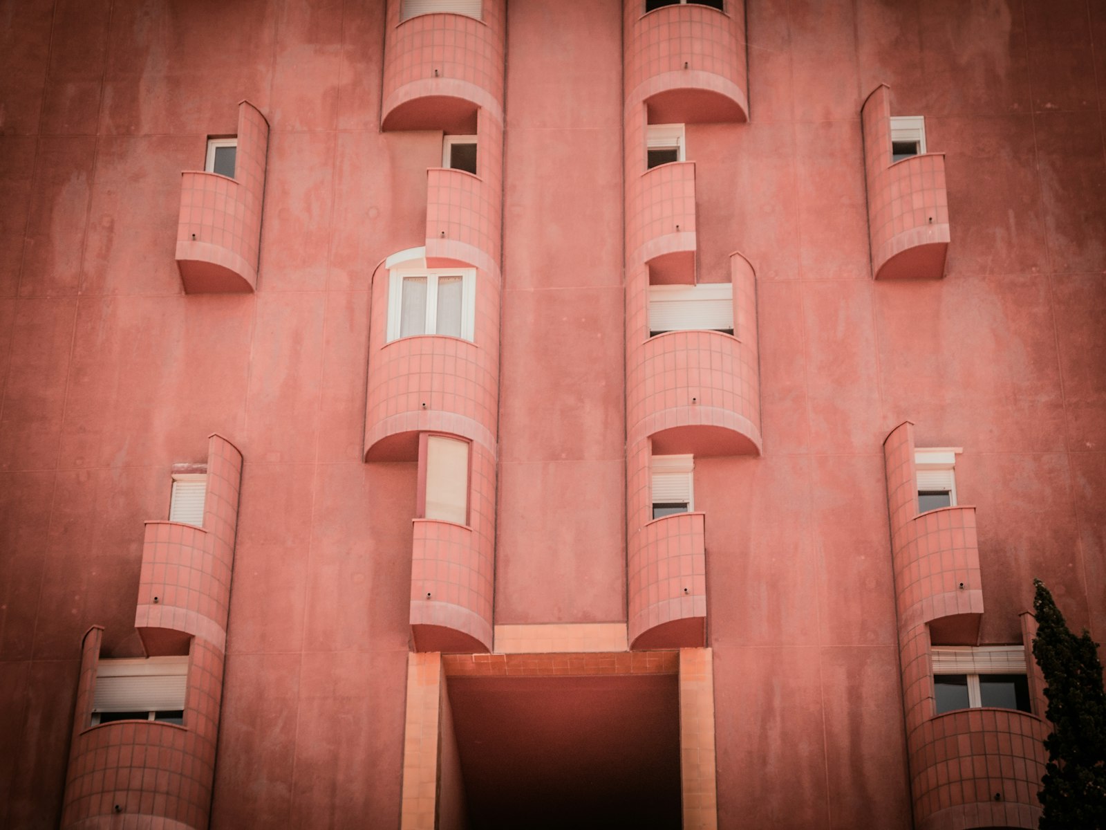 Nikon Coolpix P7000 sample photo. Pink concrete building with photography