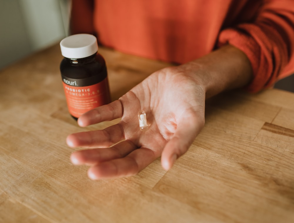 person holding medication pill