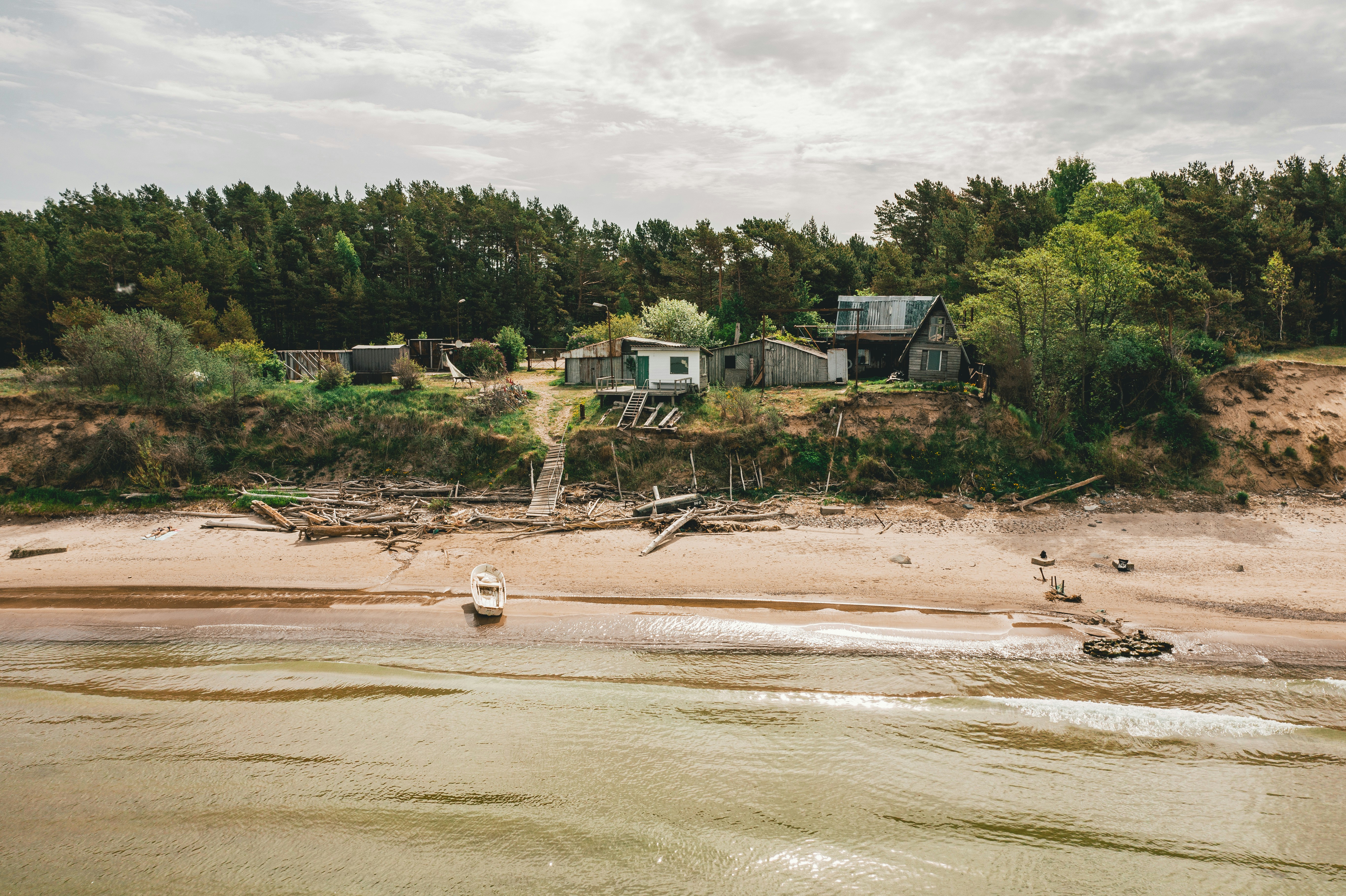 property with a secure seawall standing strong after a storm, next to an unprotected, eroded shoreline - Purpose of a seawall