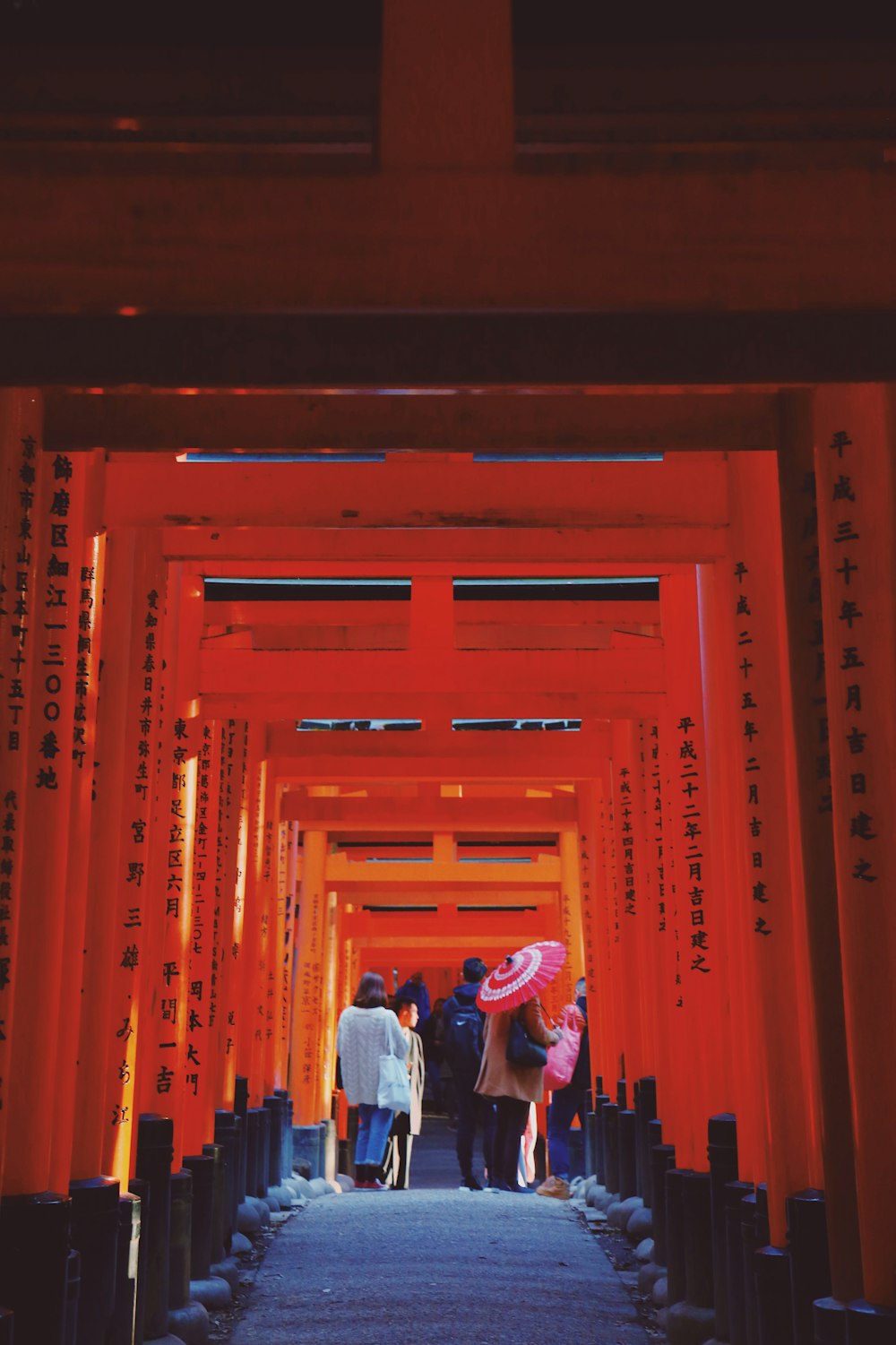 people walking in red tunnel