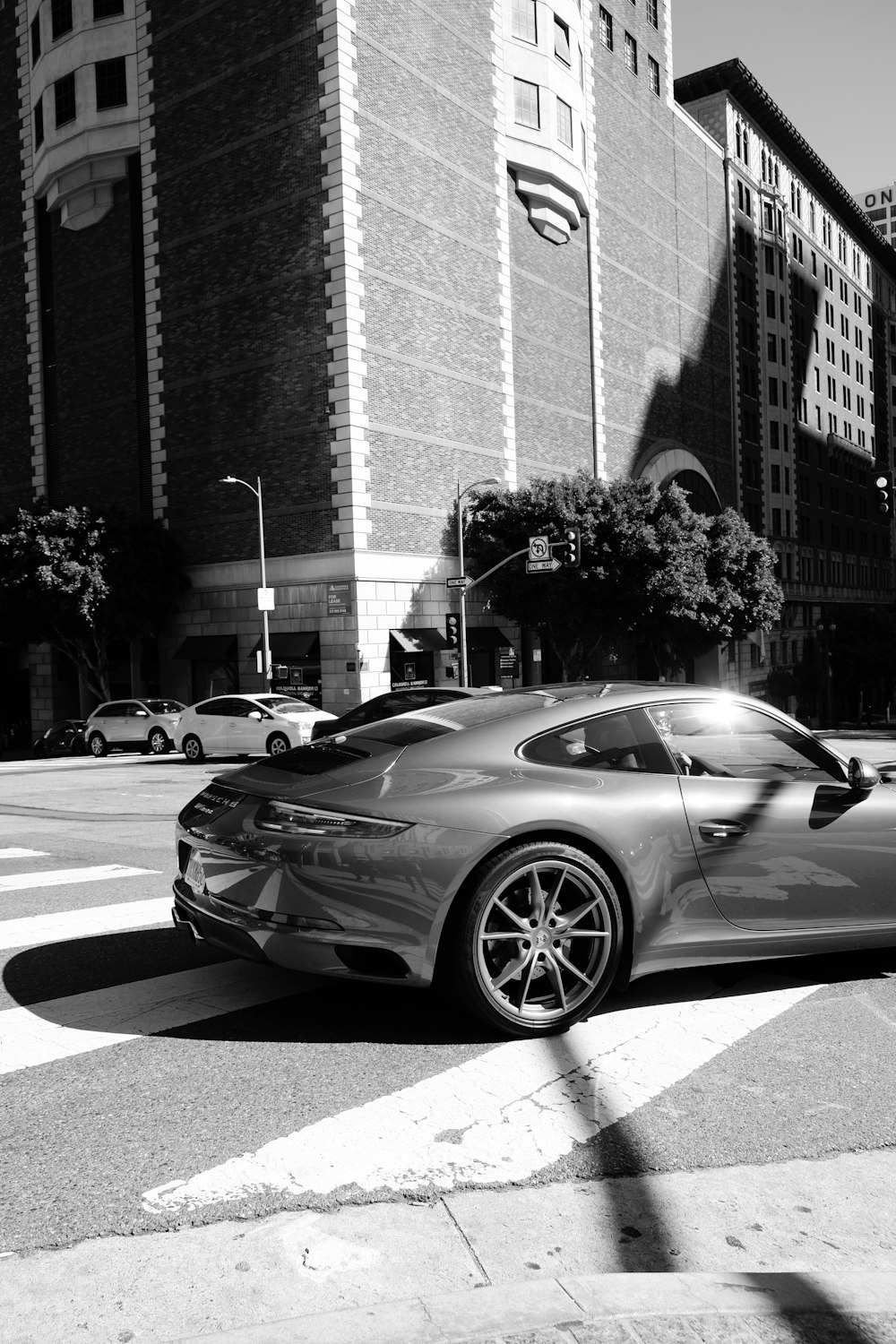 grayscale photography of vehicle on road