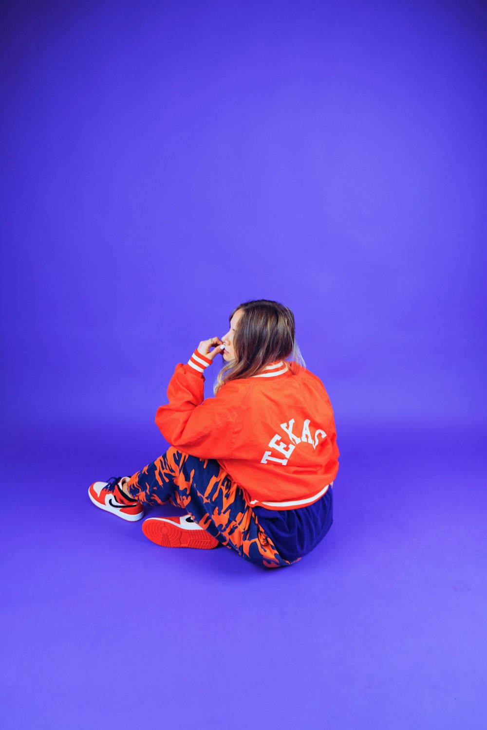 woman wearing red letterman jacket