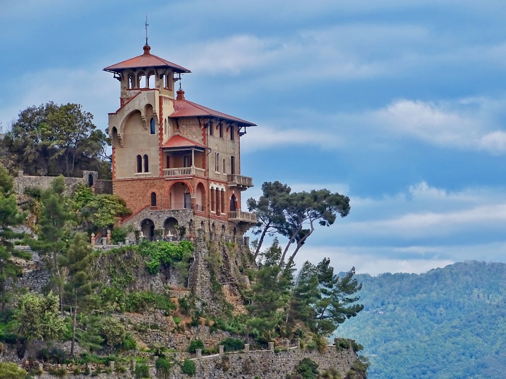 beige and brown concrete house on cliff