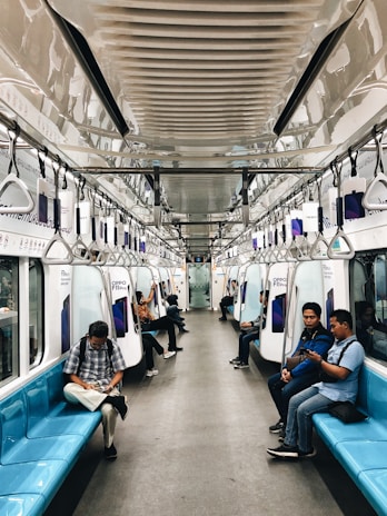 A group of diverse passengers enjoying a comfortable journey inside a well-maintained coach.