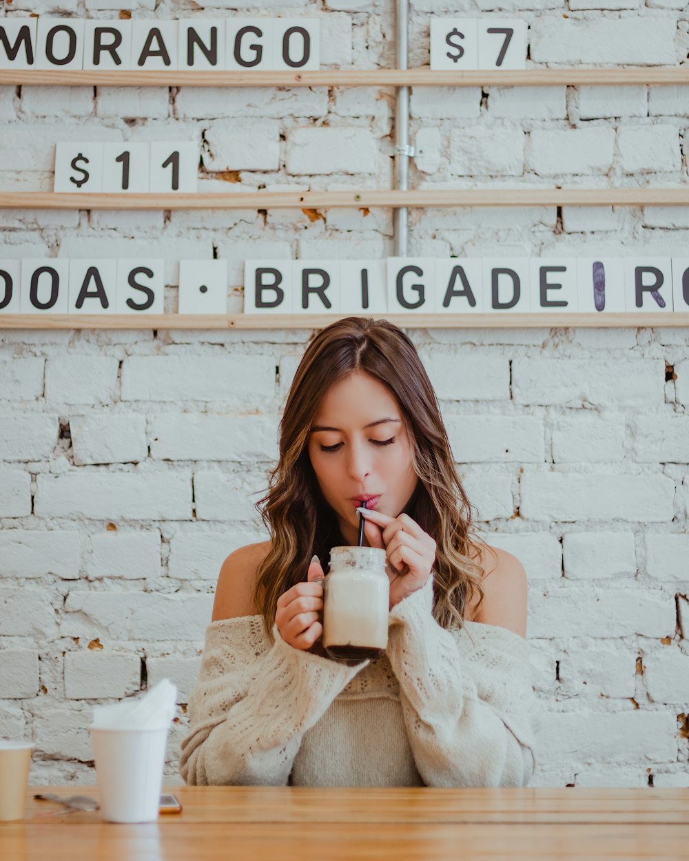 woman sipping on beverage