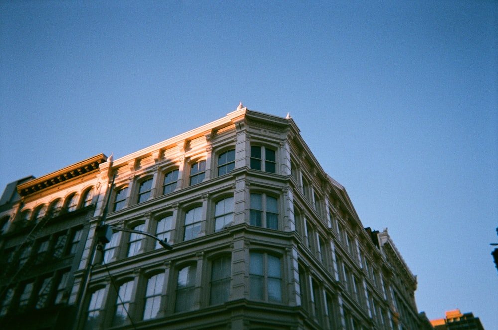 low-angle photography of gray concrete building under blue sky during daytime