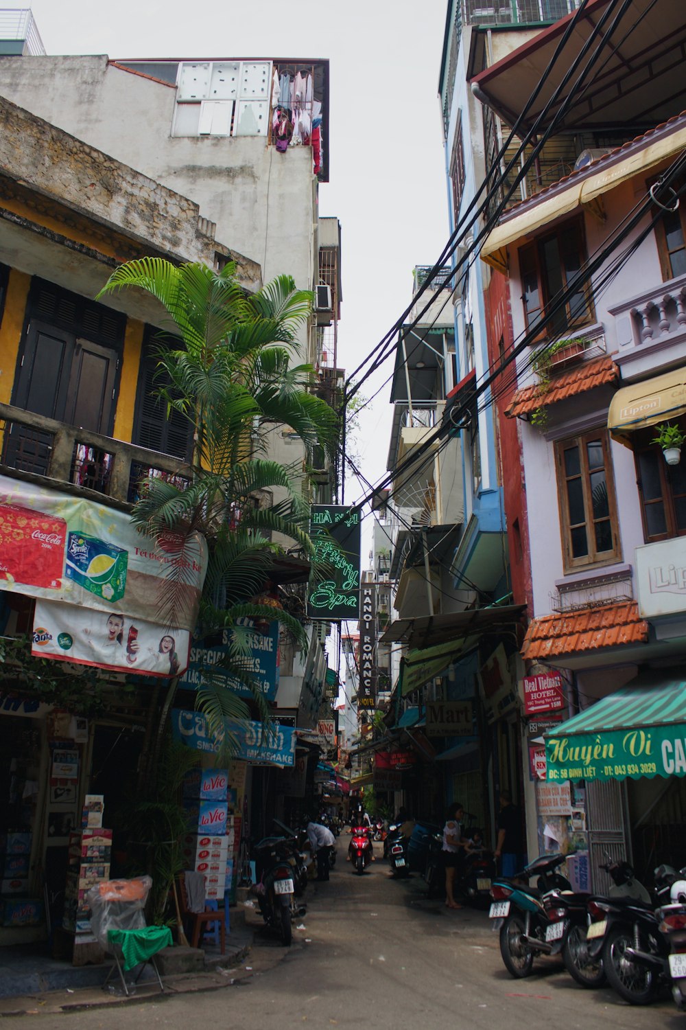 a narrow street in a city with lots of buildings