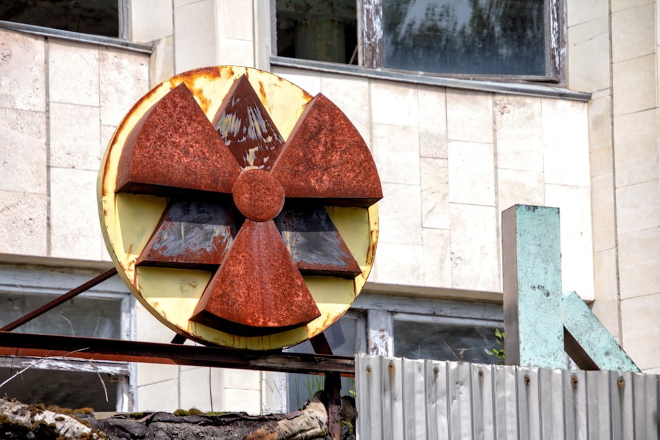 Photo of rusting metal radioactivity sign.