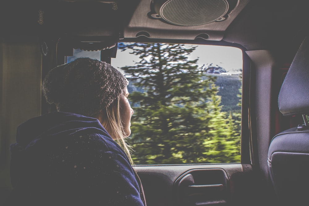 woman leaning outside a car's window