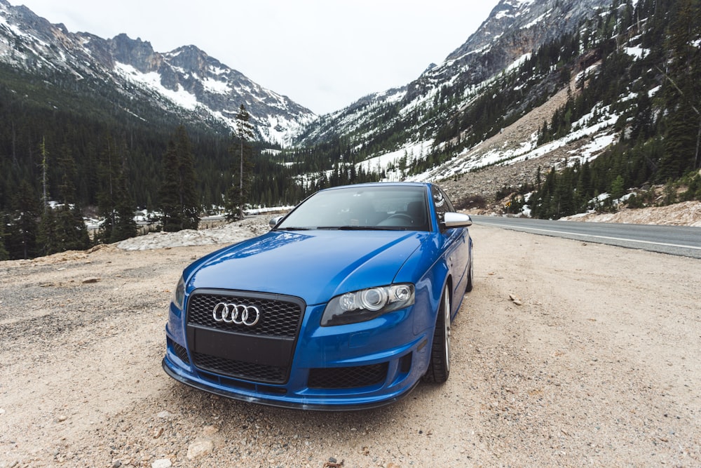 blue Audi car near road