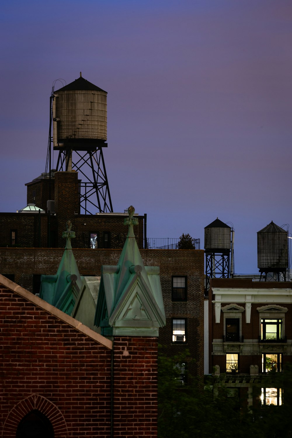 a brick building with a water tower in the background