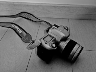 A sleek DSLR camera resting on a wooden table in the Jaffna store.