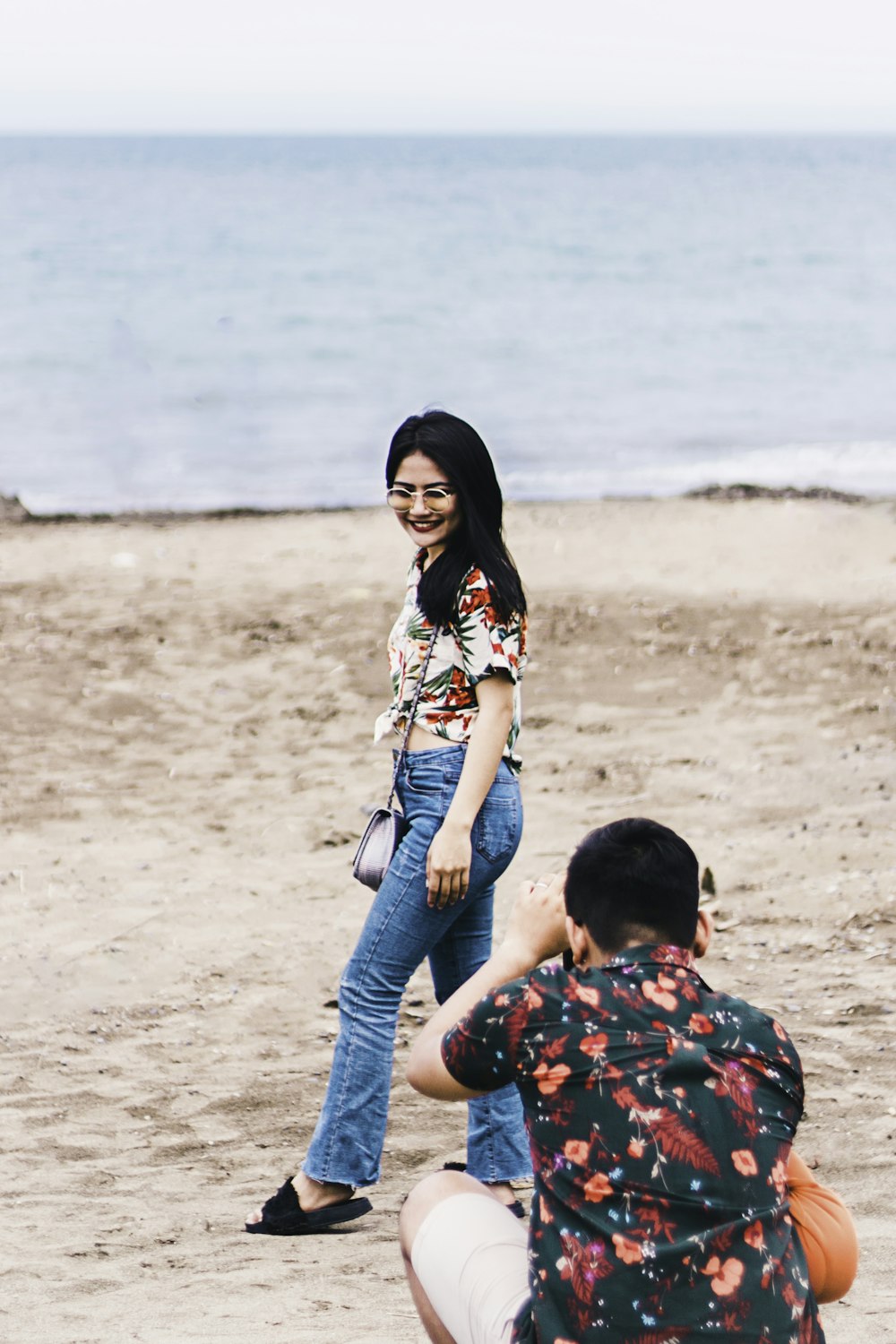 woman standing in beach during daytime