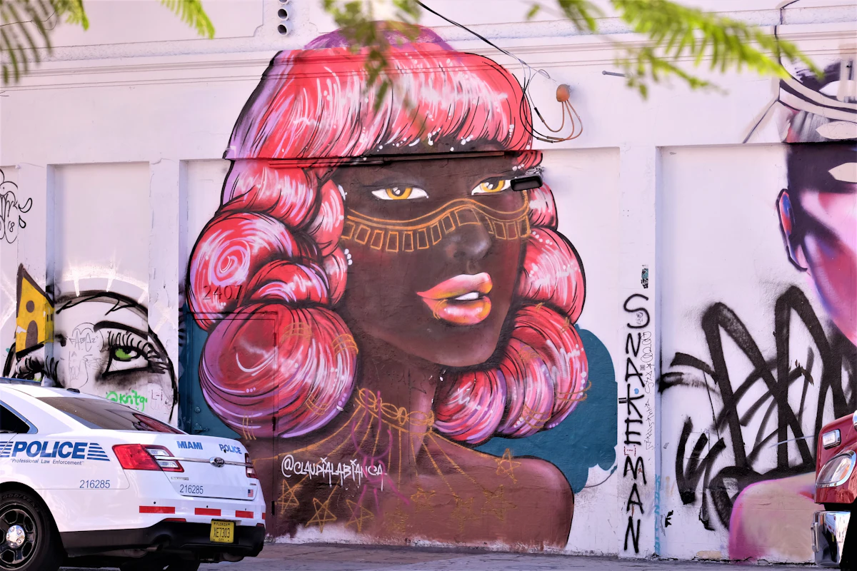 Large-scale mural of a woman's face painted on a wall in Wynwood