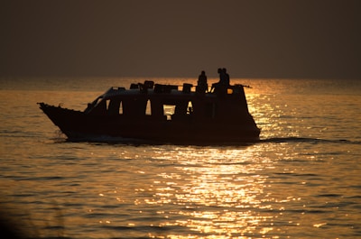 Evening glow reflecting off the water with a yacht silhouetted against the sunset.