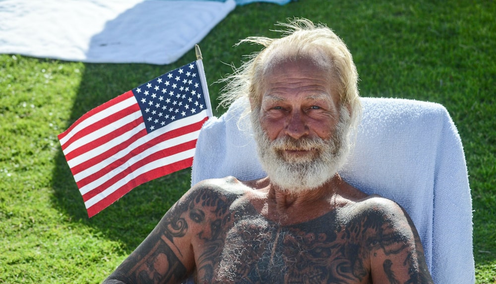 man with tattoo sitting on chair