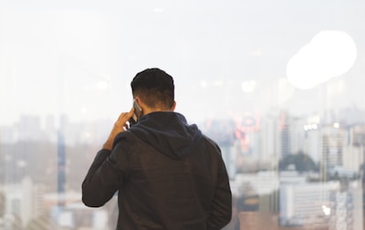 A solicitor advising a client via video call with a city skyline in the background.