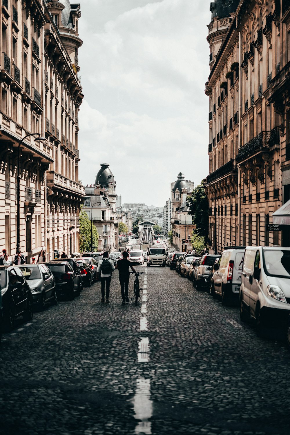 two men walking beside parked vehicle lot