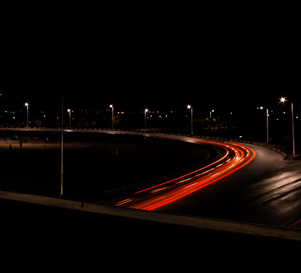 time lapse photography of road with red lights at night