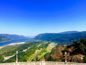 Panoramic view of a river cutting through lush green countryside