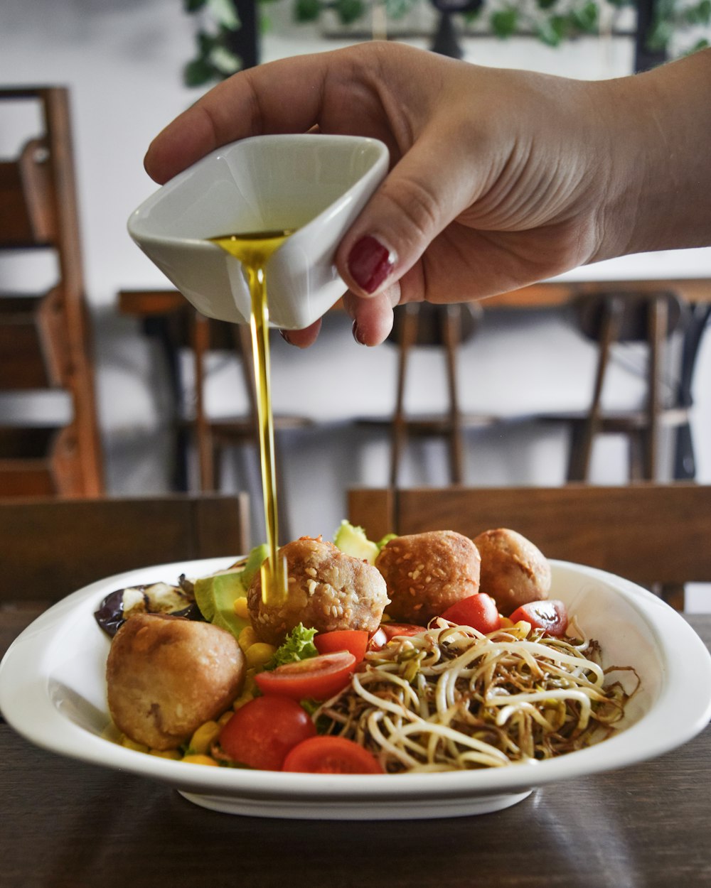 person pouring honey on cooked food