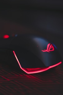 A sleek gaming mouse with RGB lighting on a dark background