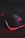 A sleek gaming mouse with a black finish and red backlighting. The mouse features a glowing logo on the top and an illuminated edge, placed on a surface with a subtle circuit-like pattern.